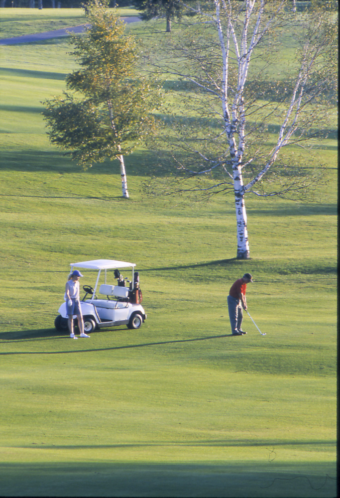 A tree-lined hole at Saranac Inn Golf Club in Saranac Lake, New York