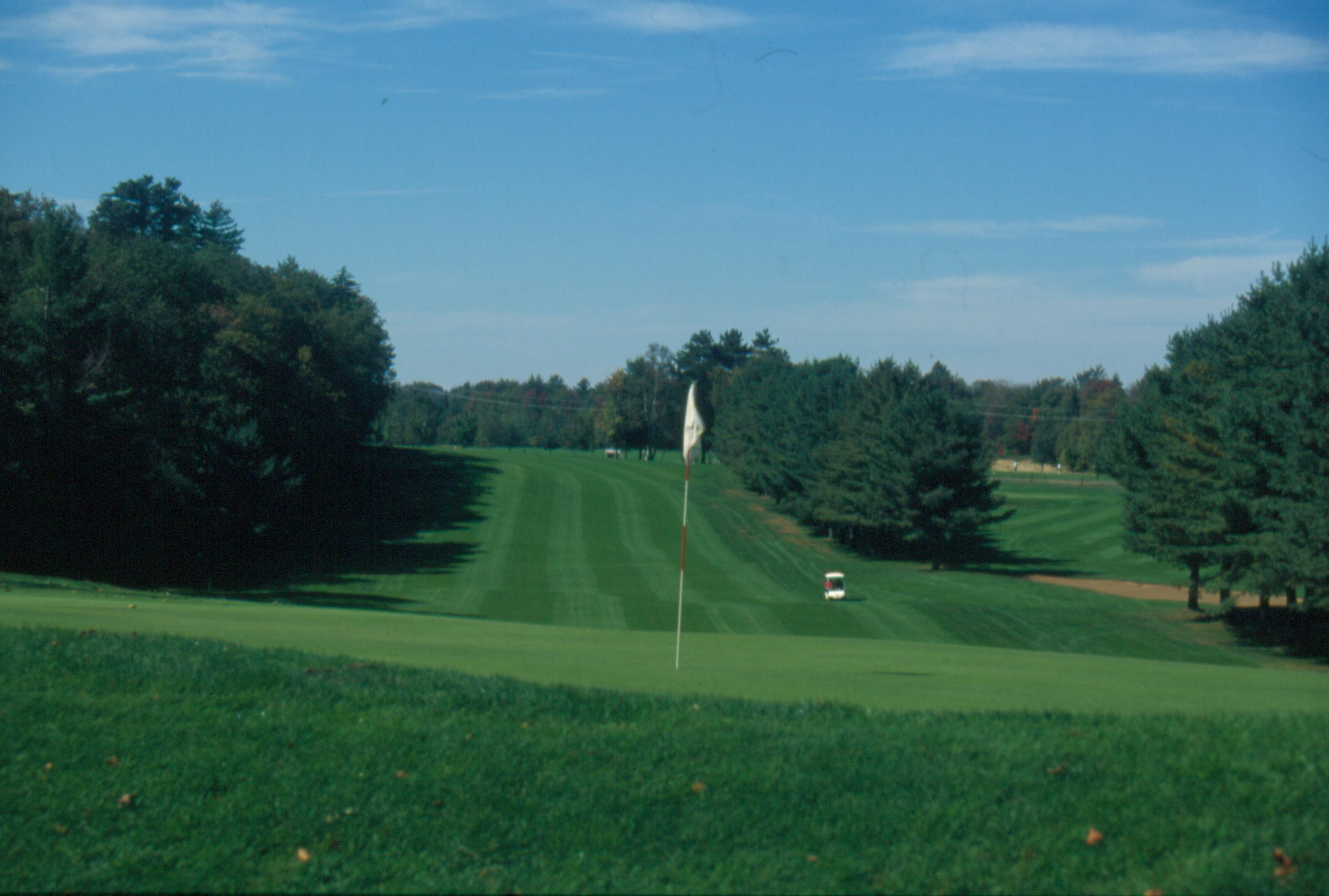 Fairway framed by Adirondack pines at Saranac Inn Golf Club